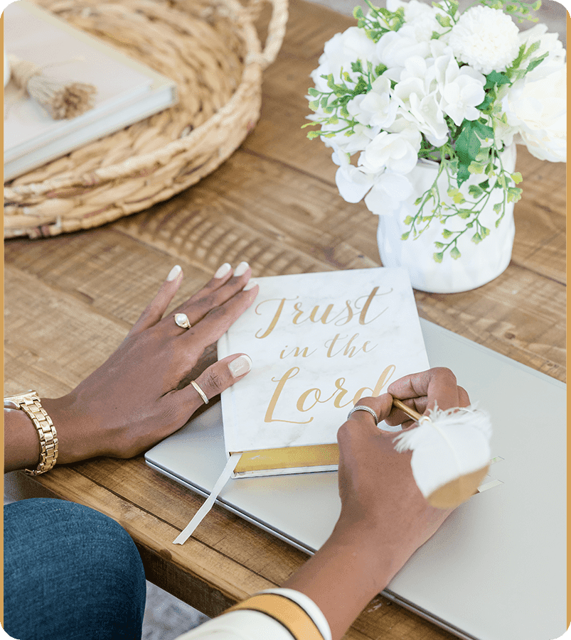 A person writing on a book with a pen